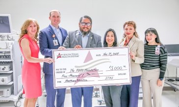 STHS staff posing with TSTC donation check