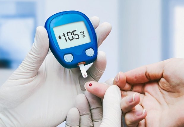 A photo of someone taking a finger-stick blood glucose test