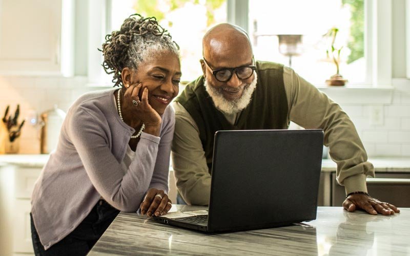 Couple completing a health assessment on their computer