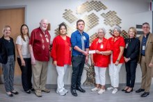 Dr. Rudy Alvarez giving a check to members of the Auxiliary to South Texas Health System