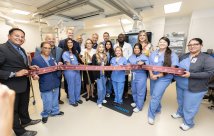 medical staff cuts ribbon at cardiac catheterization laboratory opening ceremony