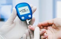A photo of someone taking a finger-stick blood glucose test