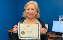 Irene Lerma holding her certificate of completion