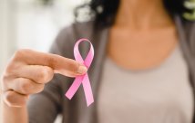 Woman holding a pink breast cancer awareness ribbon