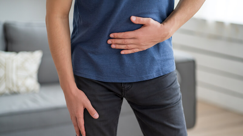 Man holding his abdomen with his hand